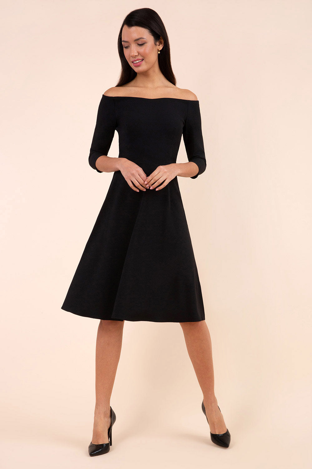 brunette model is wearing diva catwalk off shoulder swing a-line islay dress with sleeves in black colour front image 
