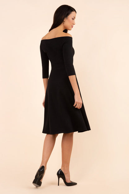 brunette model is wearing diva catwalk off shoulder swing a-line islay dress with sleeves in black colour front image 