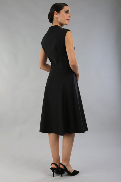 Brunette Model is wearing a sleeveless swing high neck dress with high neck in black by Diva Catwalk front