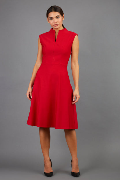 Brunette Model is wearing a sleeveless swing high neck dress with high neck in cardinal red by Diva Catwalk front