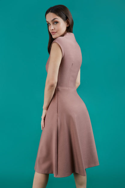 Brunette Model is wearing a sleeveless swing high neck dress with high neck in acorn brown by Diva Catwalk back