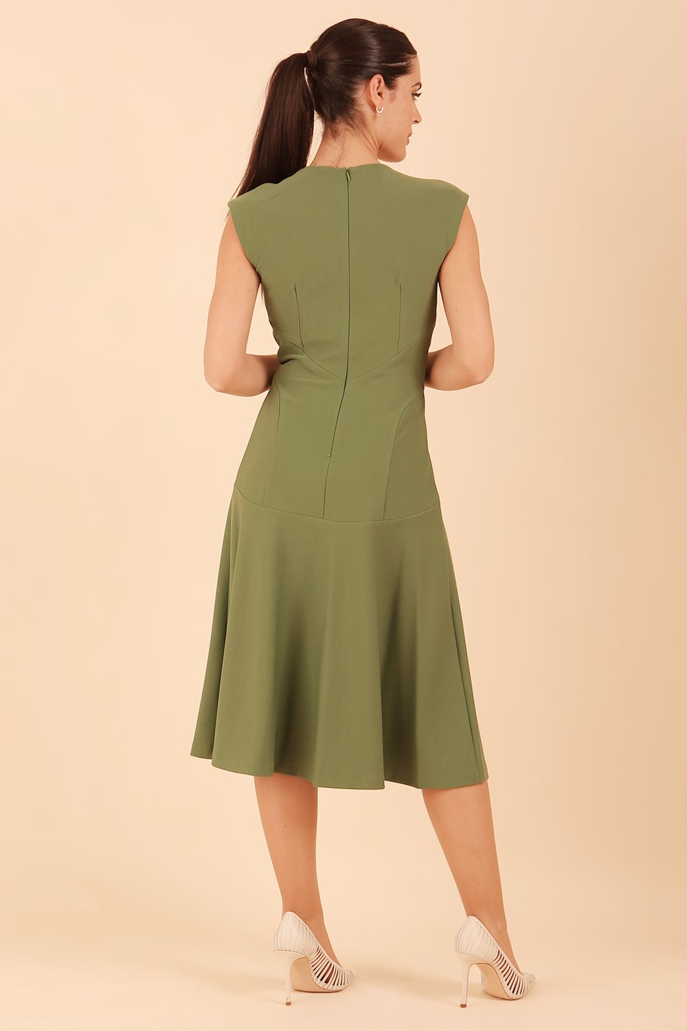 model wearing diva catwalk rochelle swing skirt a line dress without sleeves with a low v neck in vineyard green front