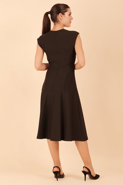 model wearing diva catwalk rochelle swing skirt a line dress without sleeves with a low v neck in black front