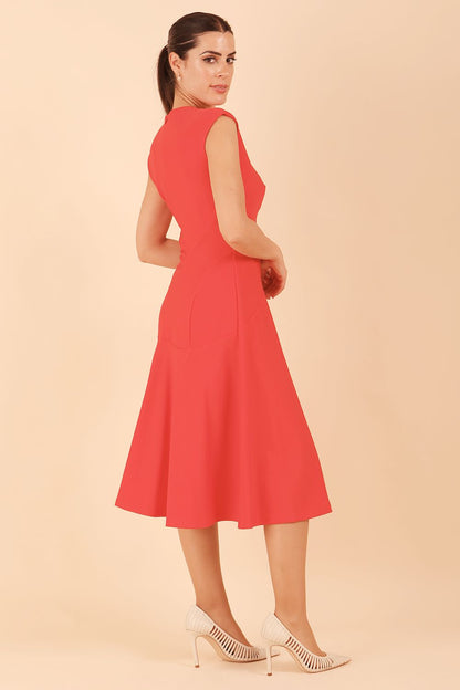 model wearing diva catwalk rochelle swing skirt a line dress without sleeves with a low v neck in red front