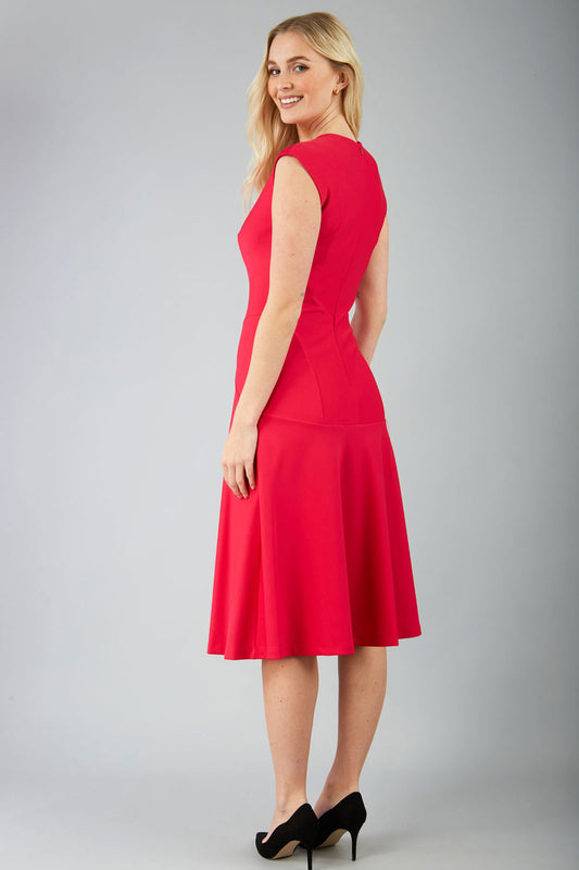 model wearing diva catwalk rochelle swing skirt a line dress without sleeves with a low v neck in yarrow pink front