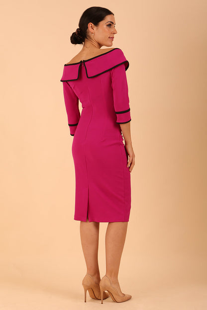 A Model is wearing an off shoulder three quarter sleeve pencil dress in magenta by diva catwalk