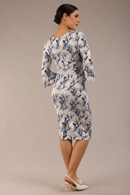 brunette model is wearing a Durham Meadow Jacquard Dress in slate blue print front side