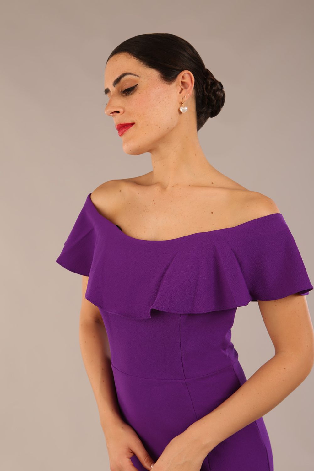 brunette model wearing diva catwalk pencil dress with off shoulder frilled front and bardot neckline in passion purple colour back (Passion Purple)