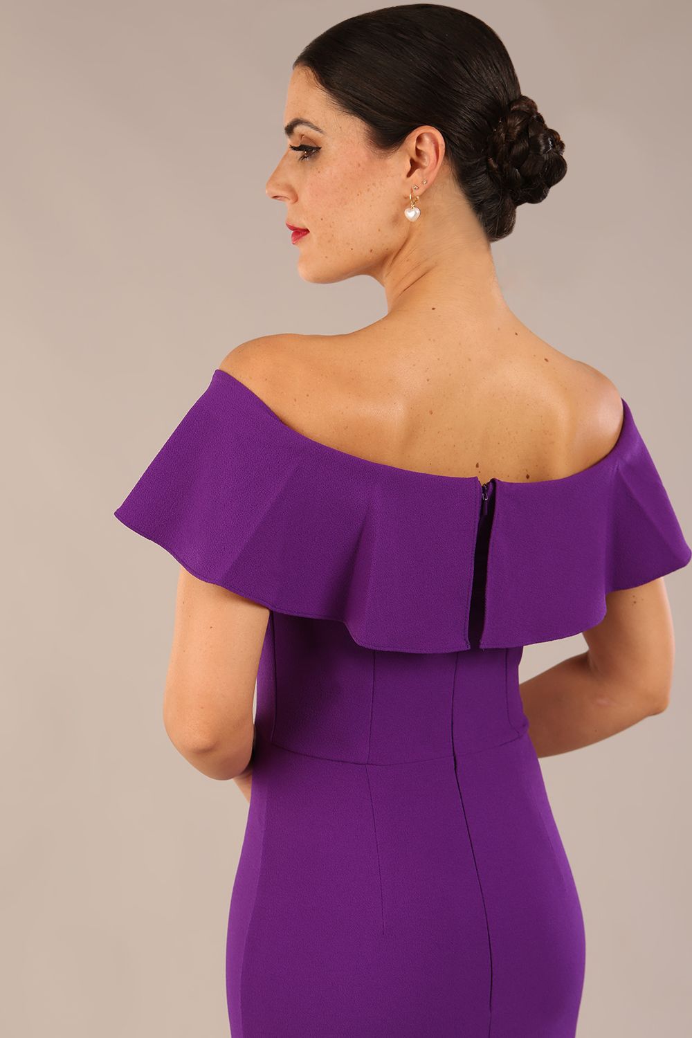 brunette model wearing diva catwalk pencil dress with off shoulder frilled front and bardot neckline in passion purple colour back (Passion Purple)