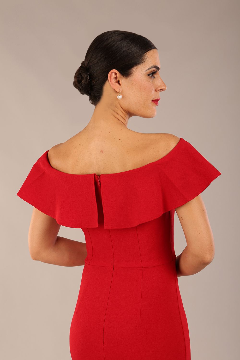 brunette model wearing diva catwalk pencil dress with off shoulder frilled front and bardot neckline in passion red  colour back (Passion Red)