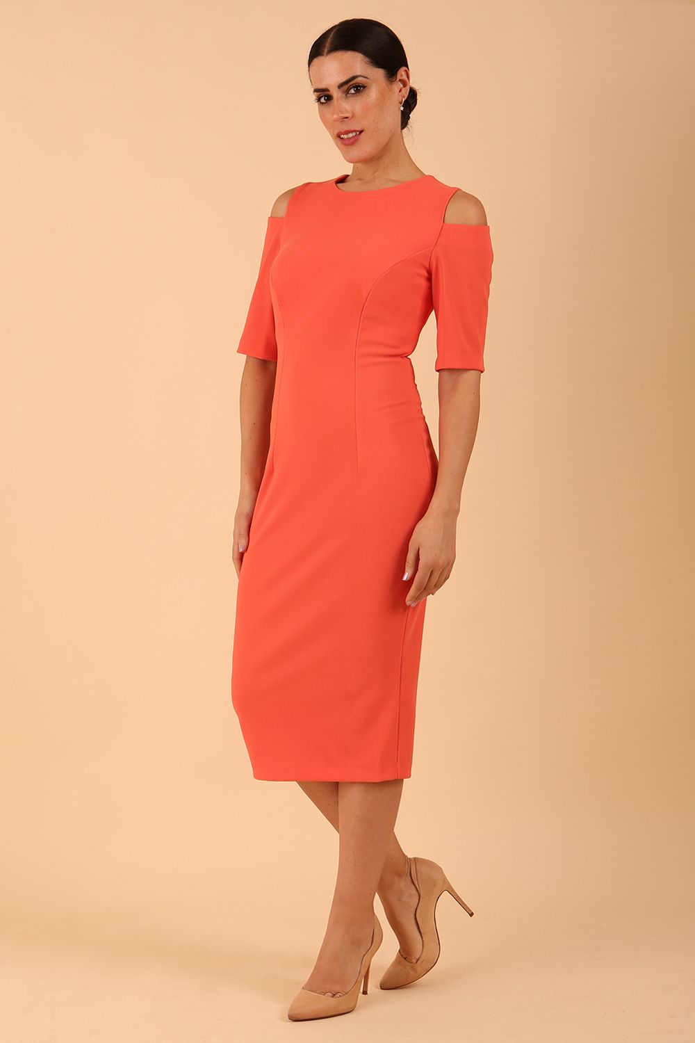 model is wearing diva catwalk solway pencil dress cold shoulder detail and rounded neckline in Sea Coral front side