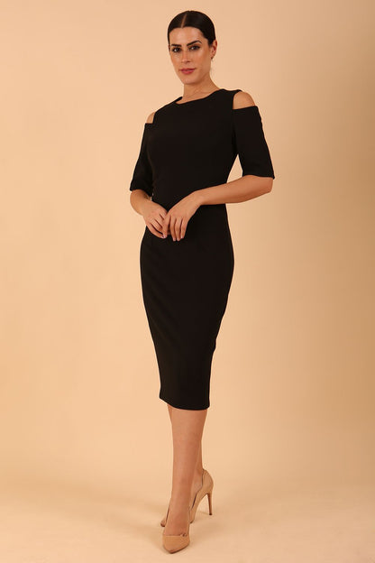 model is wearing diva catwalk solway pencil dress cold shoulder detail and rounded neckline in Black front side