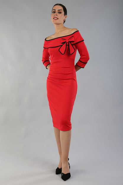 model wearing a diva catwalk Paige Bi-Stretch Dress with 3/4 sleeve, knee length, Fold over off-shoulder neckline with bow detail and with Contrast piping on sleeve cuffs and neckline in Electric Red and black colour