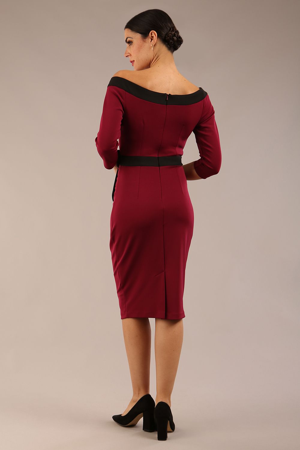 brunette model wearing diva catwalk luma pencil skirt dress with contrasting bow off shoulder with sleeves in blissful burgundy front