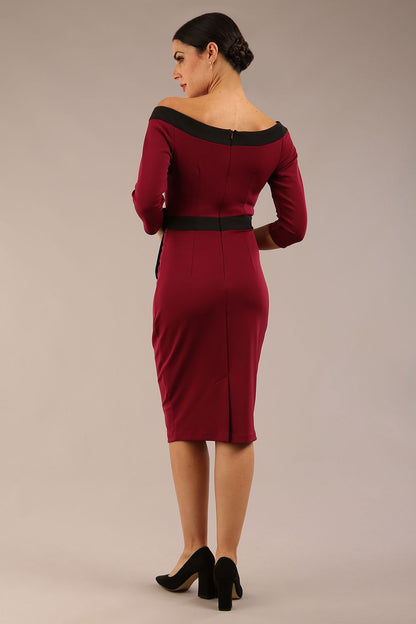 brunette model wearing diva catwalk luma pencil skirt dress with contrasting bow off shoulder with sleeves in blissful burgundy front