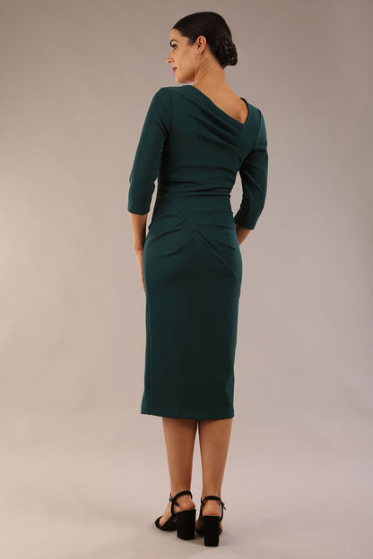 model is wearing a diva catwalk Amity Asymmetric Neckline Pleated front and back with 3/4 sleeves and front vent pencil Dress in Green Gables colour back