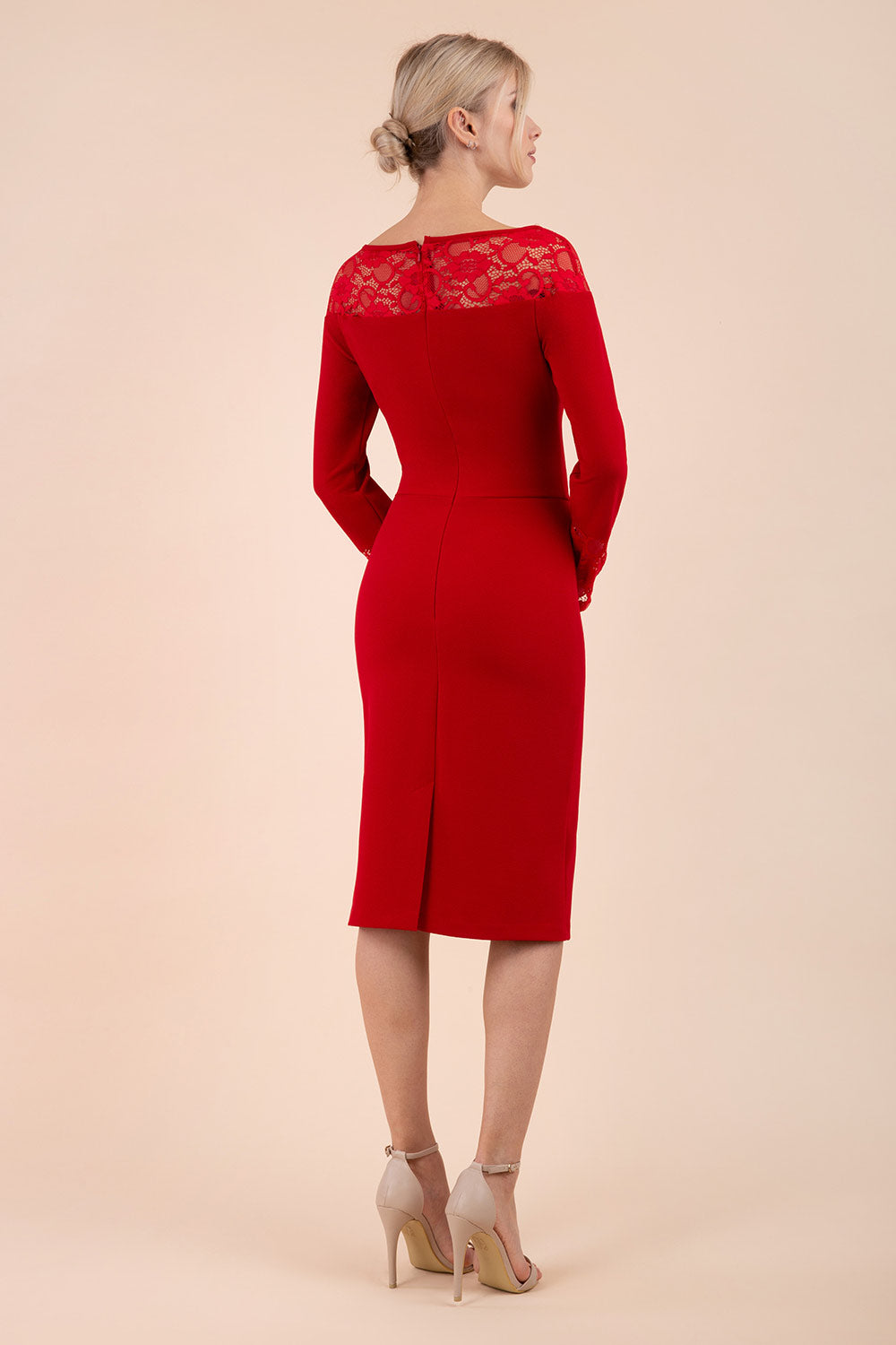 brunette model wearing diva catwalk red lace pencil dress with long sleeves and rounded lace neckline with the lace covering shoulders front