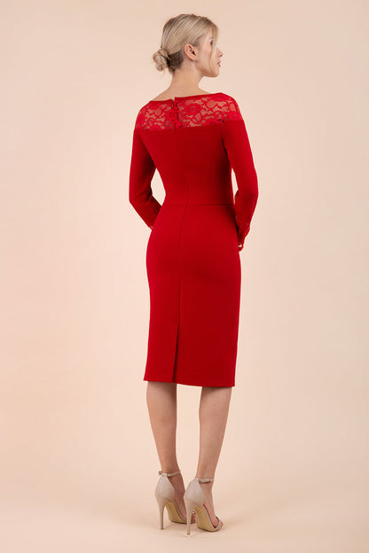 brunette model wearing diva catwalk red lace pencil dress with long sleeves and rounded lace neckline with the lace covering shoulders front