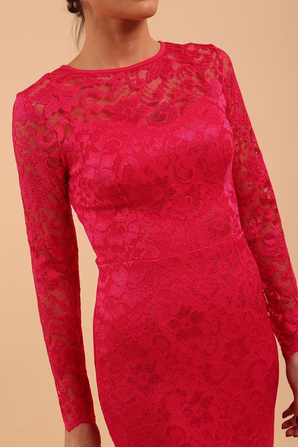 Model wearing a diva catwalk Montana Lace Dress with long lace sleeve and knee length with round lace neckline  in Yarrow Pink colour front side
