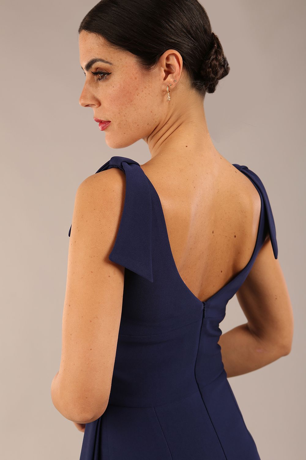 Model wearing diva catwalk Malvern Sleeveless Pencil Wiggle Dress with tie detail at waist and shoulders in Navy Blue colour front