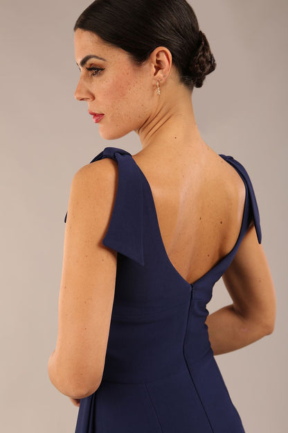 Model wearing diva catwalk Malvern Sleeveless Pencil Wiggle Dress with tie detail at waist and shoulders in Navy Blue colour front