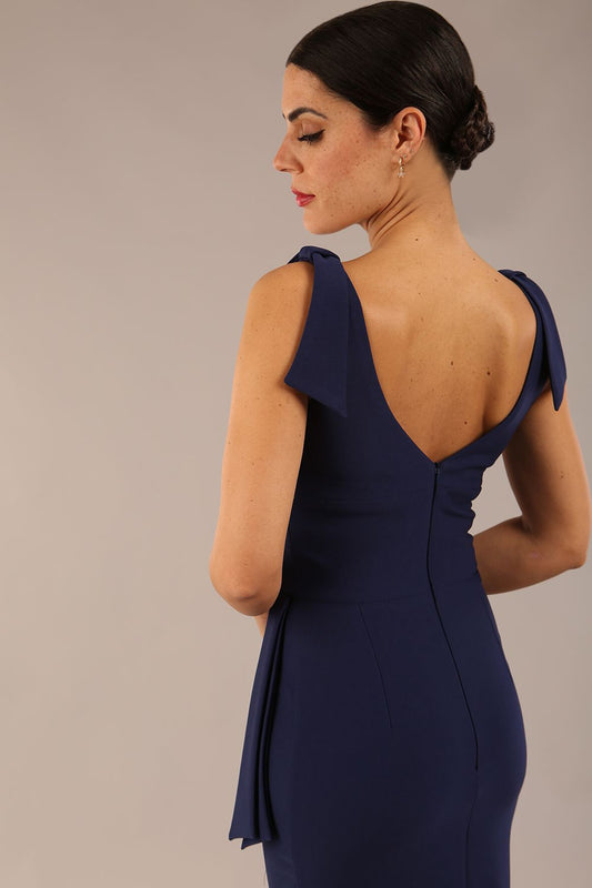 Model wearing diva catwalk Malvern Sleeveless Pencil Wiggle Dress with tie detail at waist and shoulders in Navy Blue colour front