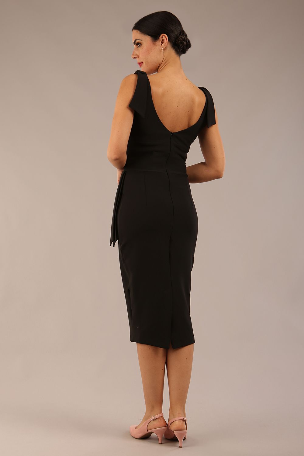 Model wearing diva catwalk Malvern Sleeveless Pencil Wiggle Dress with tie detail at waist and shoulders and open back in Black colour front