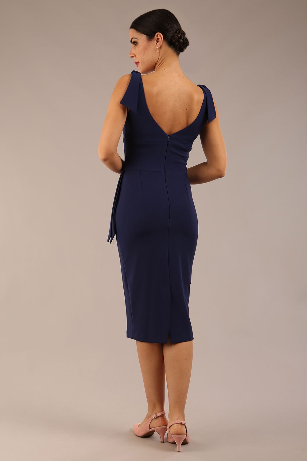 Model wearing diva catwalk Malvern Sleeveless Pencil Wiggle Dress with tie detail at waist and shoulders in Navy Blue colour front