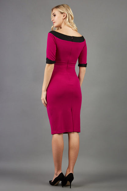 blonde model is wearing diva catwalk fellini sweetheart neckline fitted pencil dress with sleeves with cuff in colour pink with black contrasting detail front