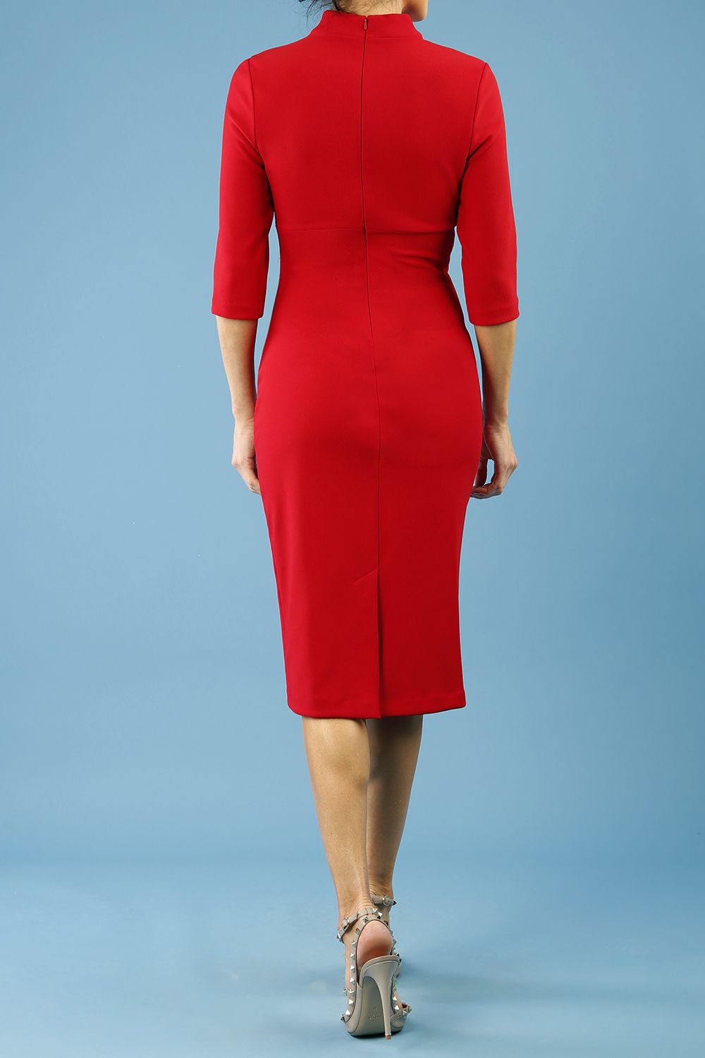 model is wearing diva catwalk pinhoe pencil dress with sleeved and high neckline with a keyhole detail in the middle and pleating across the tummy area in true red front