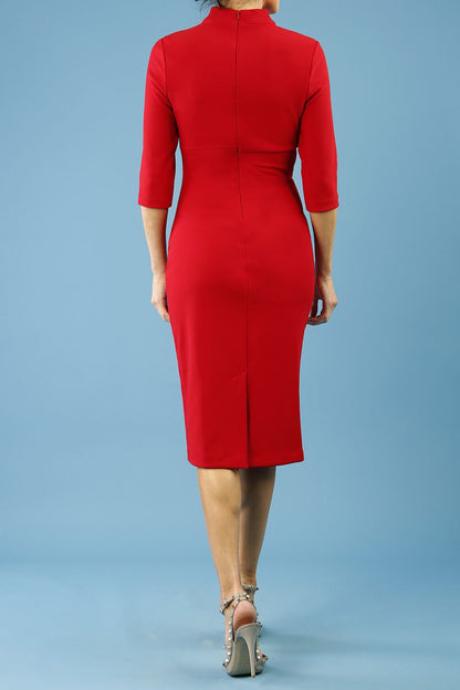 model is wearing diva catwalk pinhoe pencil dress with sleeved and high neckline with a keyhole detail in the middle and pleating across the tummy area in true red front