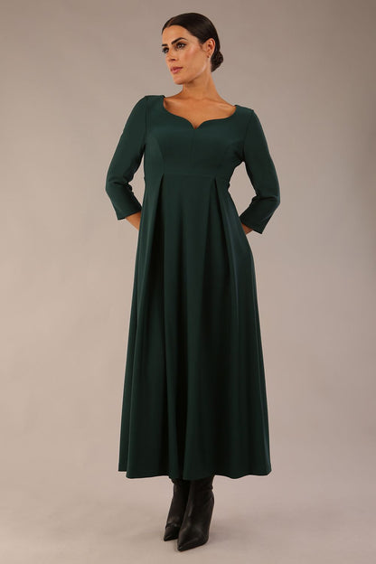 Brunette Model is wearing 3/4 sleeve sweetheart neckline swing forest green dress (Forest Green)