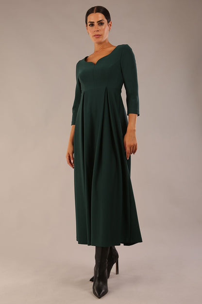 Brunette Model is wearing 3/4 sleeve sweetheart neckline swing forest green dress (Forest Green)