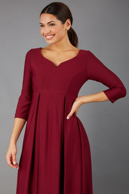 Brunette Model is wearing 3/4 sleeve sweetheart neckline  swing burgundy dress (Blissful Burgundy)