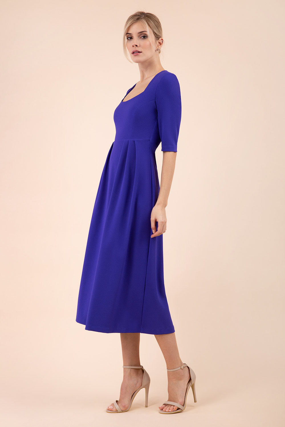 model wearing a diva catwalk Padstow Midi A-line Dress elbow length sleeves and midi length with empire waistline in spectrum indigo colour
