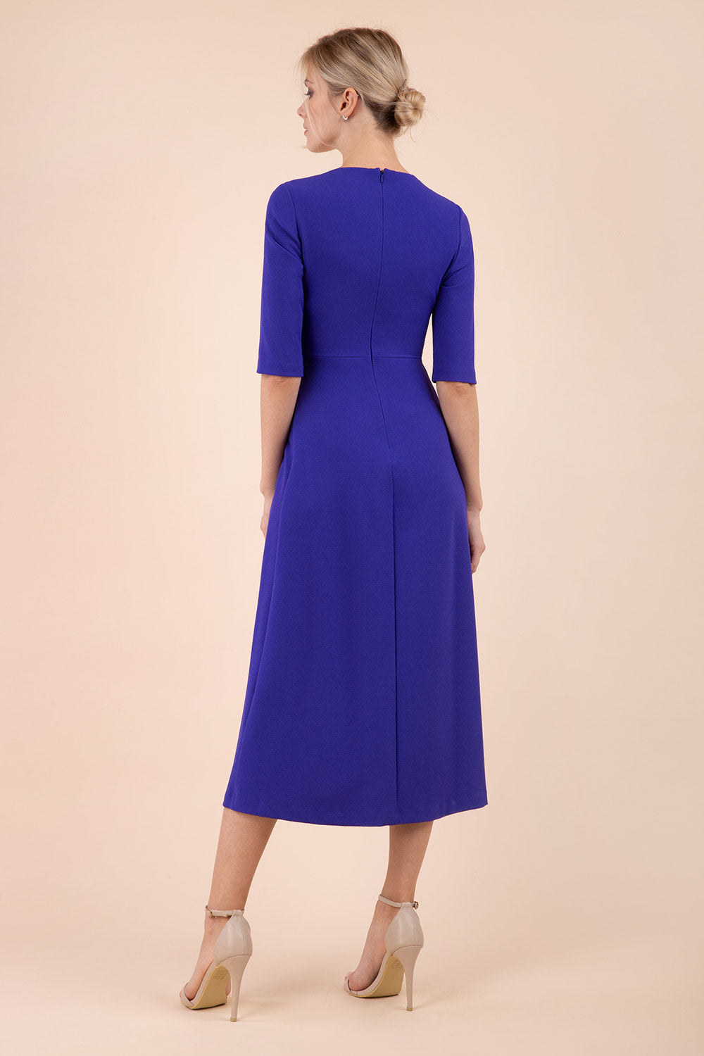 model wearing a diva catwalk Padstow Midi A-line Dress elbow length sleeves and midi length with empire waistline in spectrum indigo colour