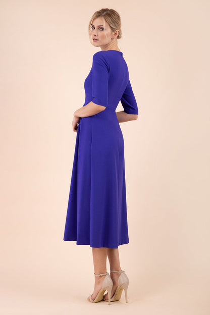 model wearing a diva catwalk Padstow Midi A-line Dress elbow length sleeves and midi length with empire waistline in spectrum indigo colour