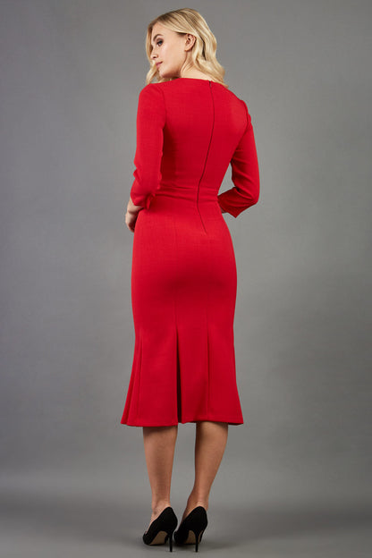 blonde model is wearing diva catwalk senne midaxi sleeved dress with fishtail and rounded neckline with a slit in the middle in red front
