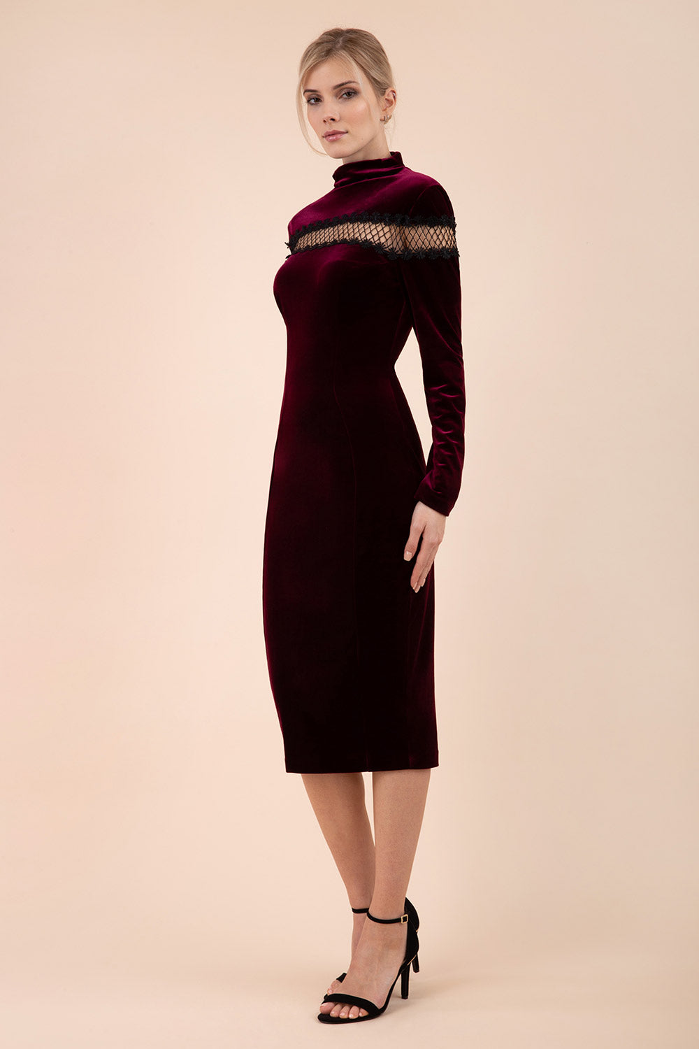 blonde model wearing diva catwalk burgundy pencil dress called trocadero pencil midaxi style with funnel neckline and lace detail and long sleeves front