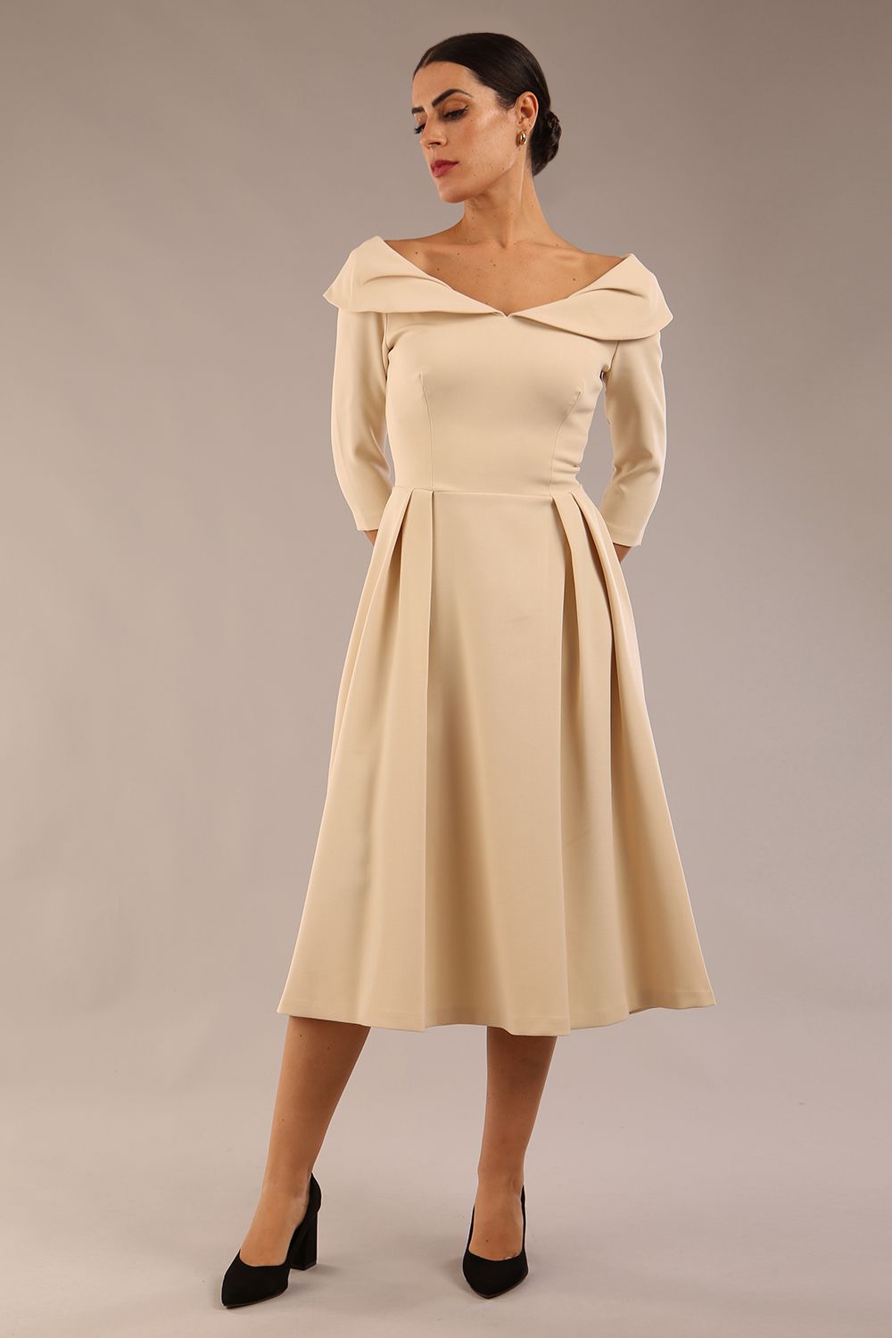 Model wearing Diva Catwalk Chesterton Sleeved dress with oversized collar detail and a-line swing pleated skirt in colour sandshell beige front