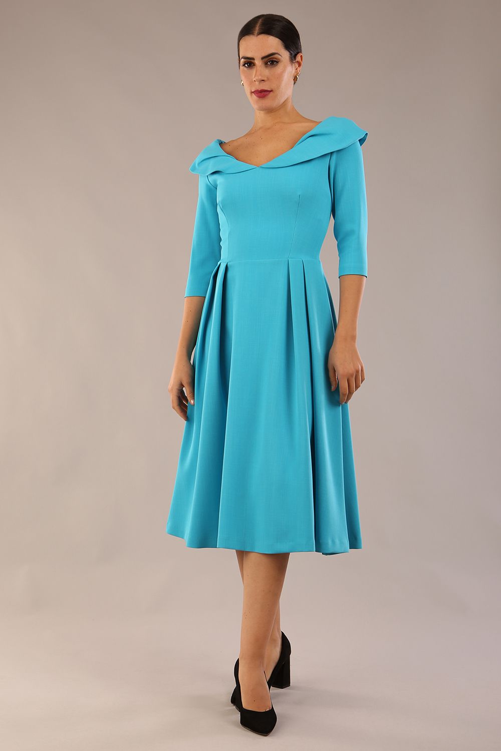 Model wearing Diva Catwalk Chesterton Sleeved dress with oversized collar detail and a-line swing pleated skirt in colour azure blue front side