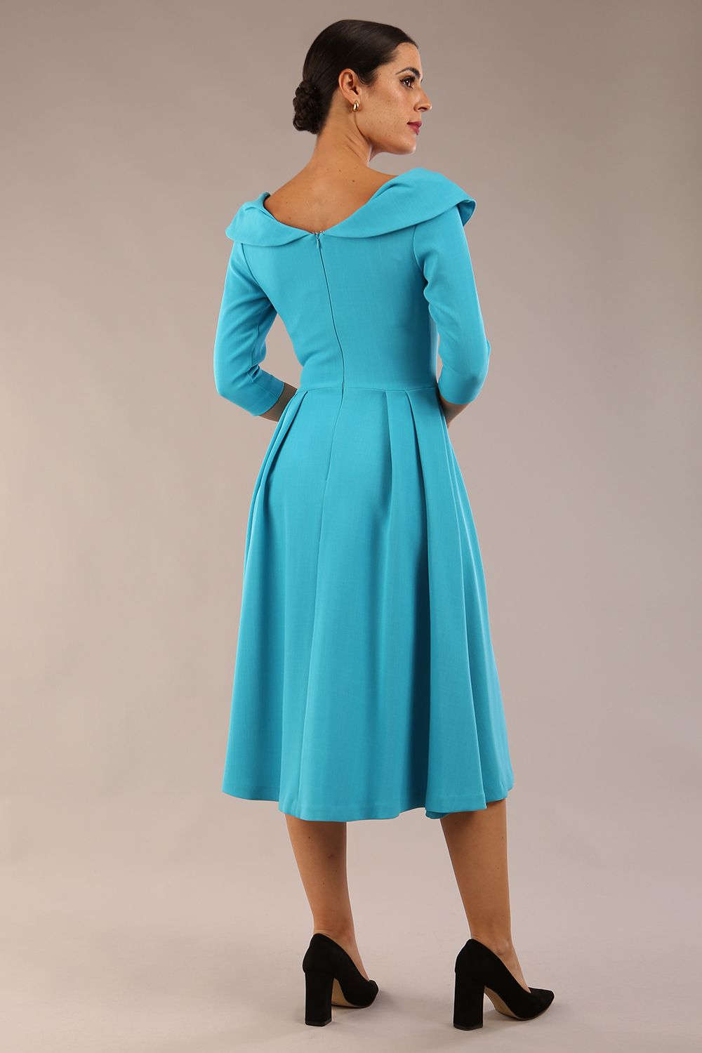 Model wearing Diva Catwalk Chesterton Sleeved dress with oversized collar detail and a-line swing pleated skirt in colour azure blue front side