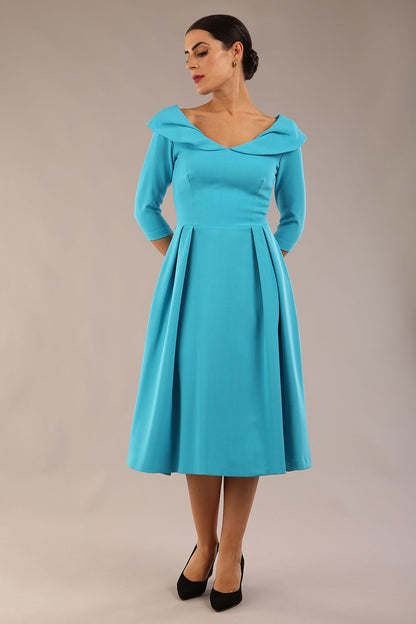 Model wearing Diva Catwalk Chesterton Sleeved dress with oversized collar detail and a-line swing pleated skirt in colour azure blue front side