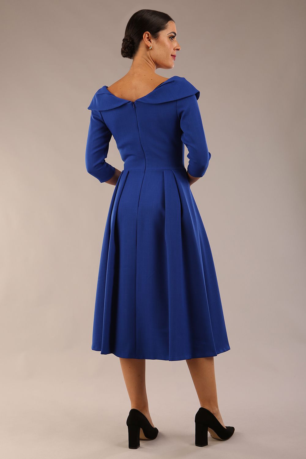 Model wearing Diva Catwalk Chesterton Sleeved dress with oversized collar detail and a-line swing pleated skirt in colour cobalt blue front