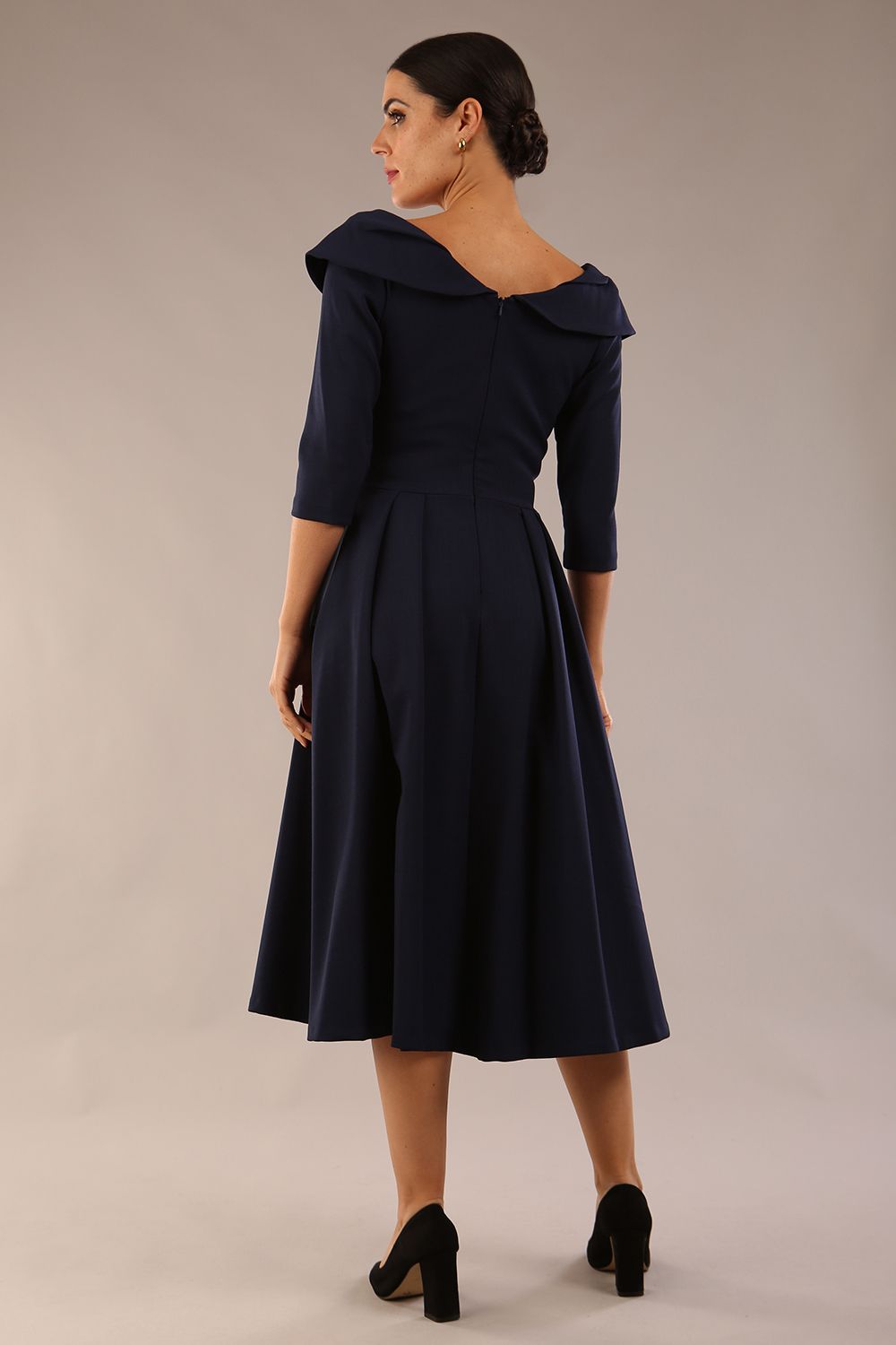 Model wearing Diva Catwalk Chesterton Sleeved dress with oversized collar detail and a-line swing pleated skirt in colour navy blue front