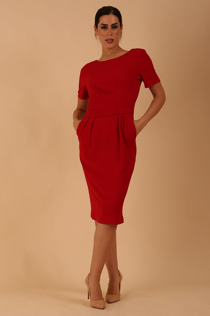 Brunette model is wearing marcel stretch short sleeve pencil dress image in tango red colour