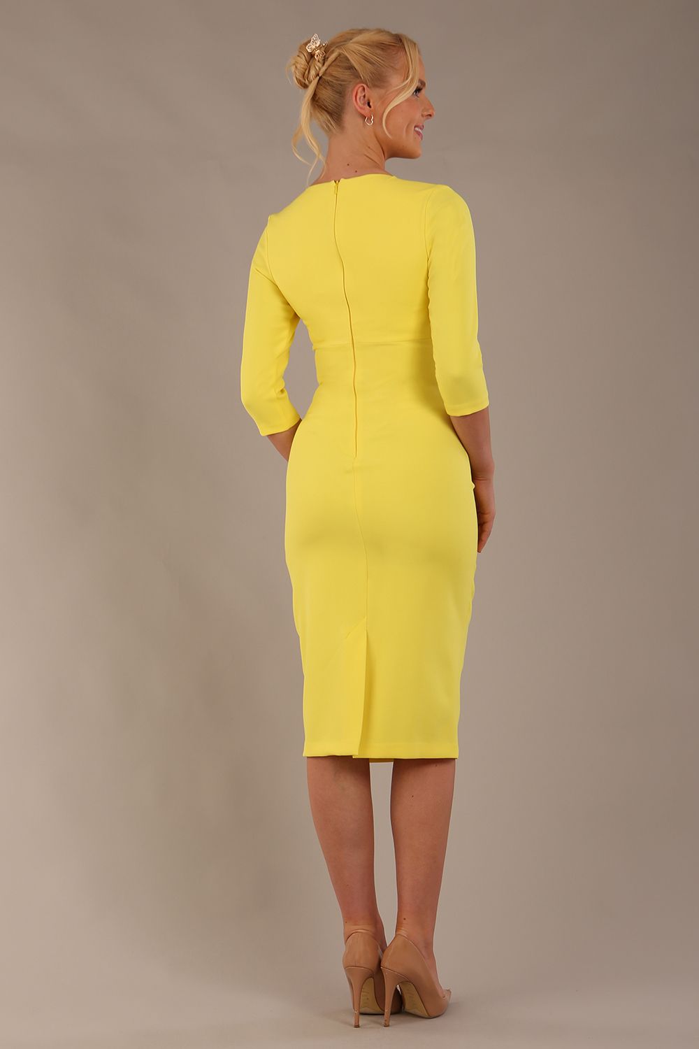 model wearing diva catwalk ubrique pencil dress with a keyhole detail and sleeves in blazing yellow colour (Blazing Yellow)