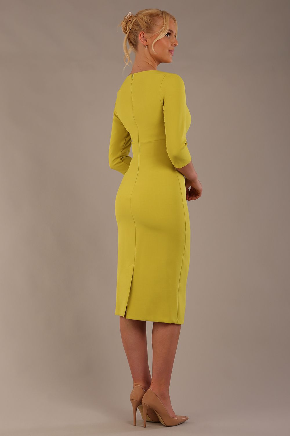 model is wearing the Diva Catwalk Ubrique pencil dress with Long sleeves and keyhole detail in Citrus Green fabric colour front (Citrus Green)