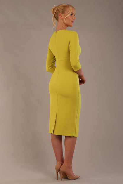 model is wearing the Diva Catwalk Ubrique pencil dress with Long sleeves and keyhole detail in Citrus Green fabric colour front (Citrus Green)