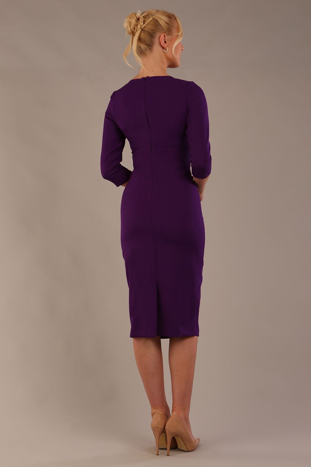 model is wearing the Diva Catwalk Ubrique pencil dress with Long sleeves and keyhole detail in Deep Purple fabric colour (Deep Purple)